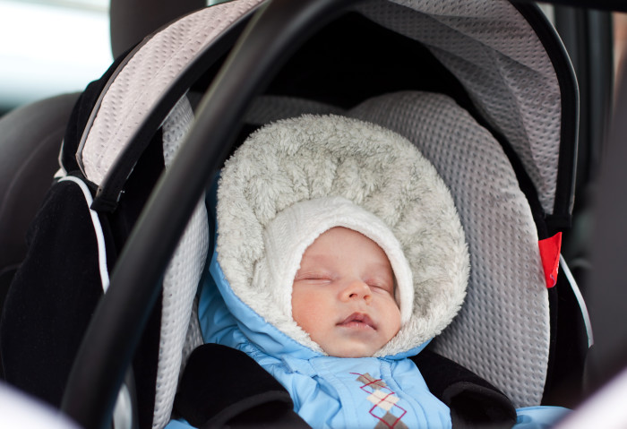 Newborn sleeping in the car seat