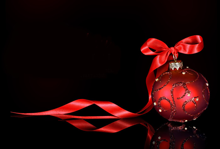 Christmas background with a red ornament and ribbon