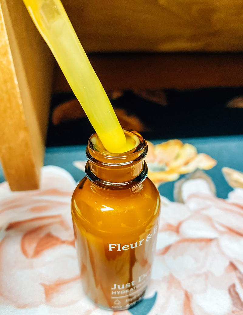 Fleur and Bee Just Dew It Serum Wand Pulling Out of Bottle
