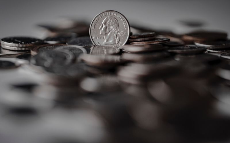 silver-round-coins-on-brown-wooden-surface